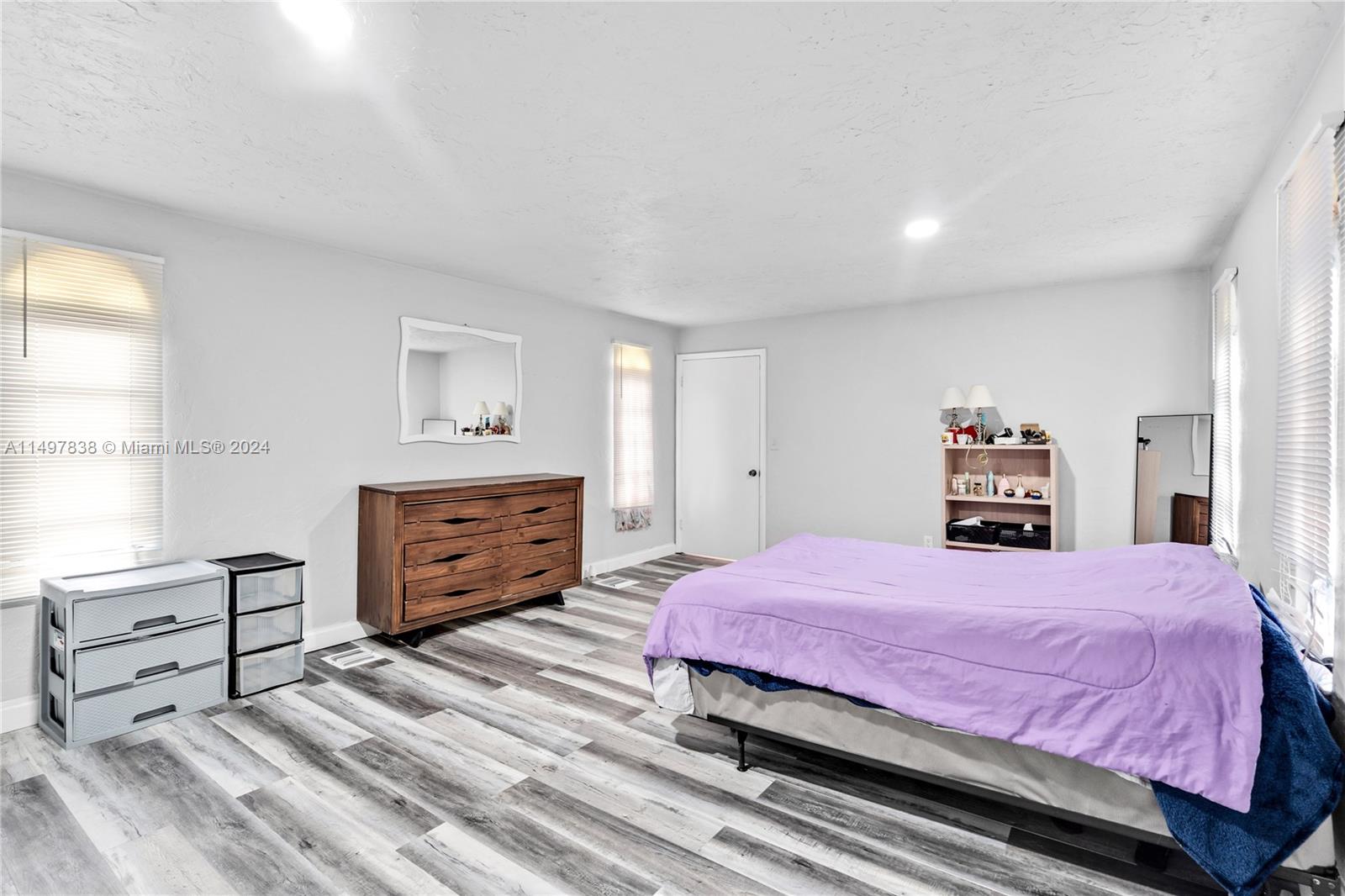 10981 Southwest 44th Street Miami, FL 33165 - Photo 36 of 52 a bedroom with a bed and a dresser