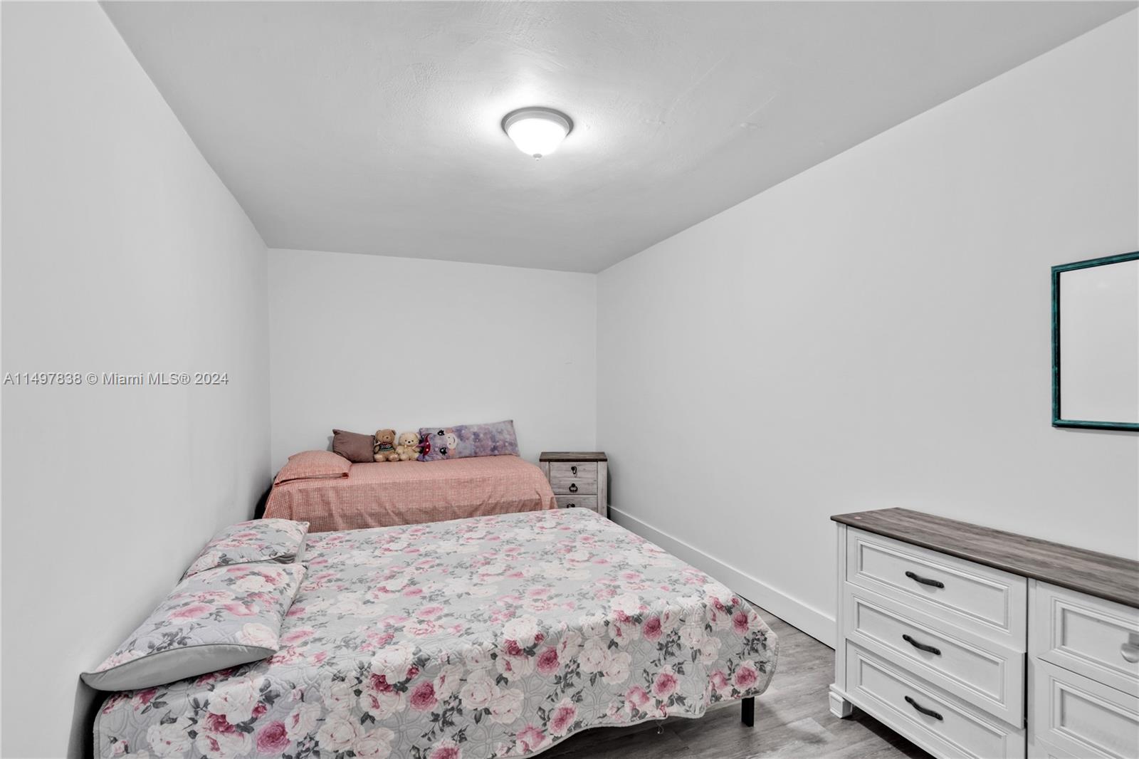 10981 Southwest 44th Street Miami, FL 33165 - Photo 39 of 52 a bedroom with a bed and a window