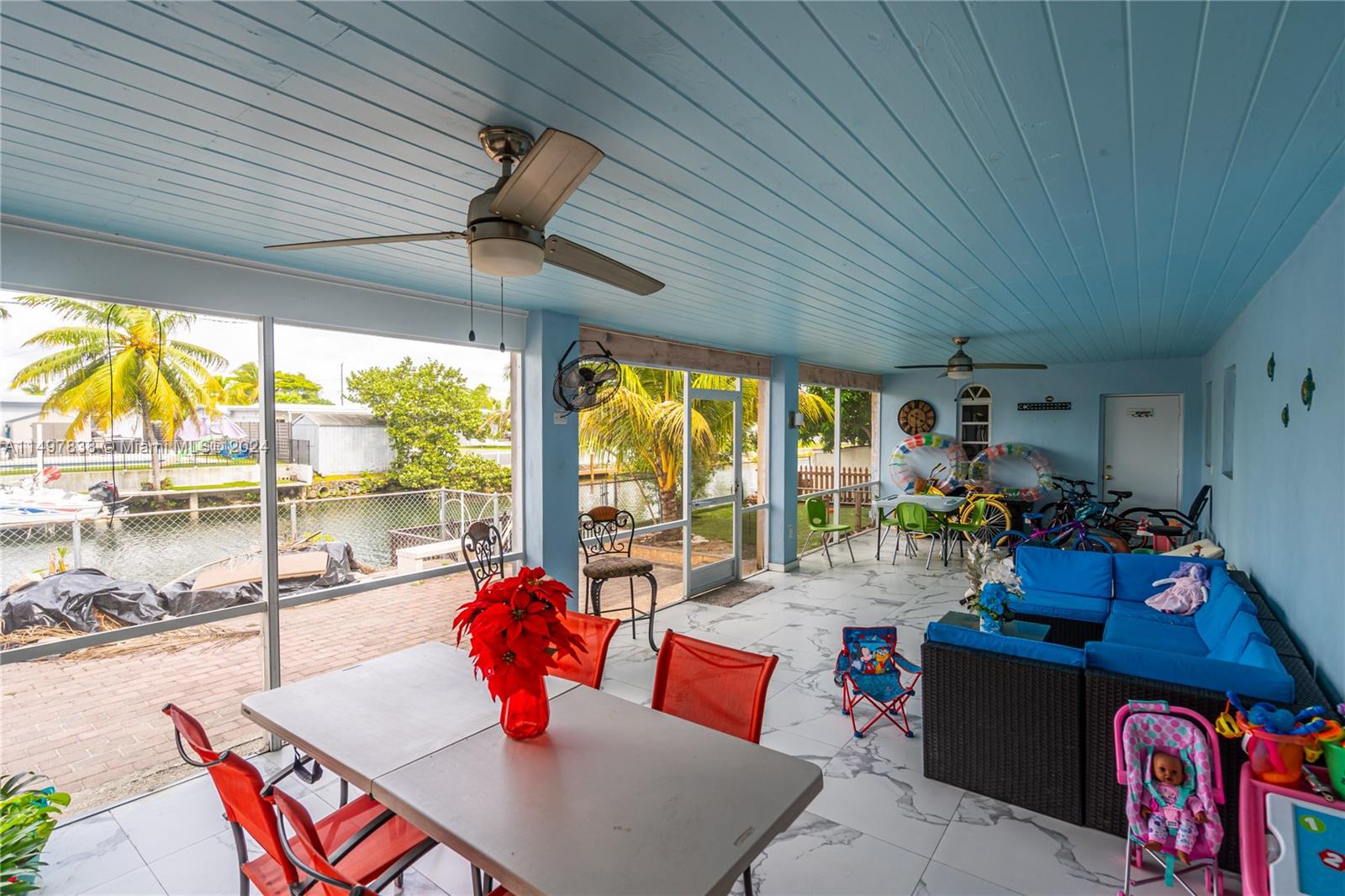 10981 Southwest 44th Street Miami, FL 33165 - Photo 42 of 52 a living room with furniture kitchen view and a large window