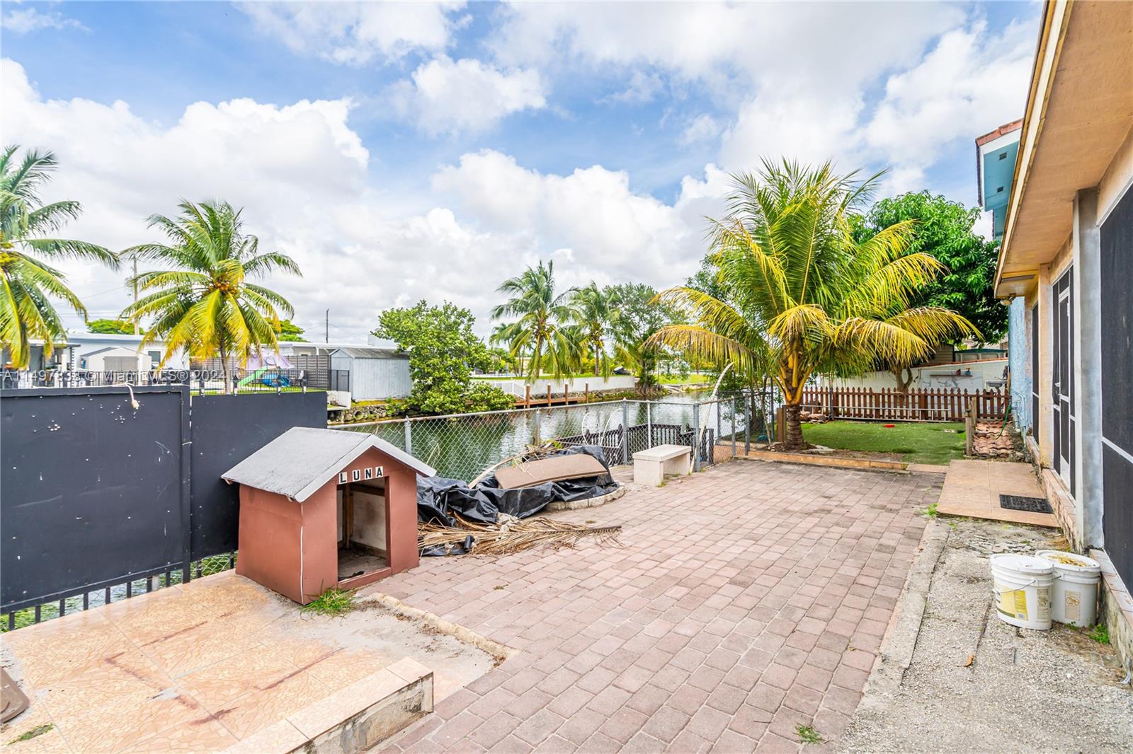 10981 Southwest 44th Street Miami, FL 33165 - Photo 44 of 52 a row of palm trees and swimming pool in the backyard of a house