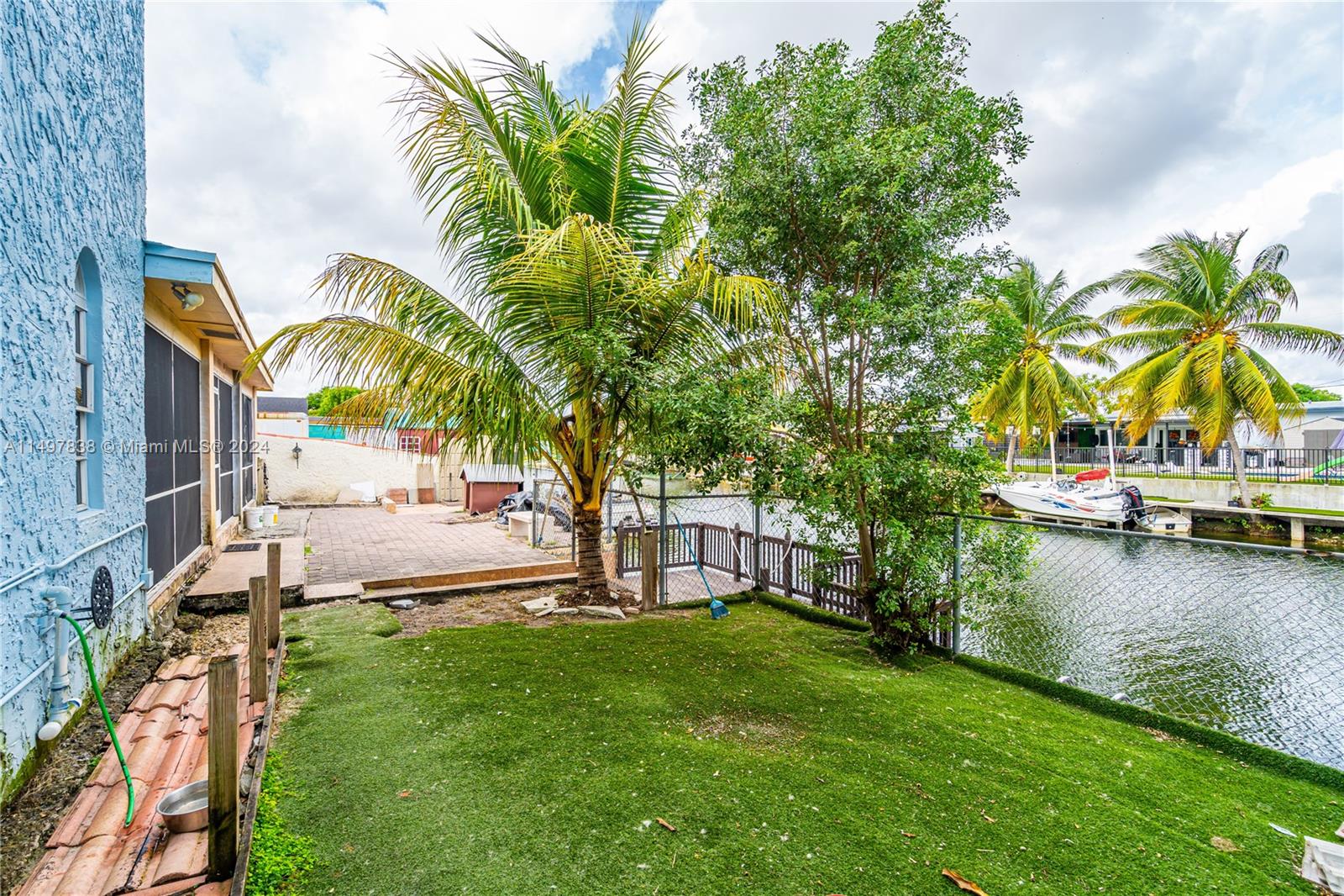 10981 Southwest 44th Street Miami, FL 33165 - Photo 45 of 52 a view of a swimming pool with a garden and trees
