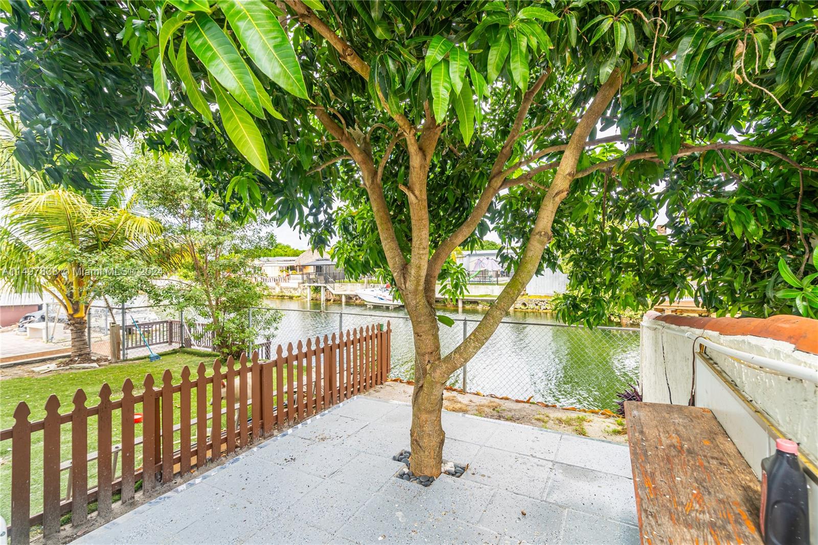 10981 Southwest 44th Street Miami, FL 33165 - Photo 52 of 52 a view of backyard with large trees and wooden fence