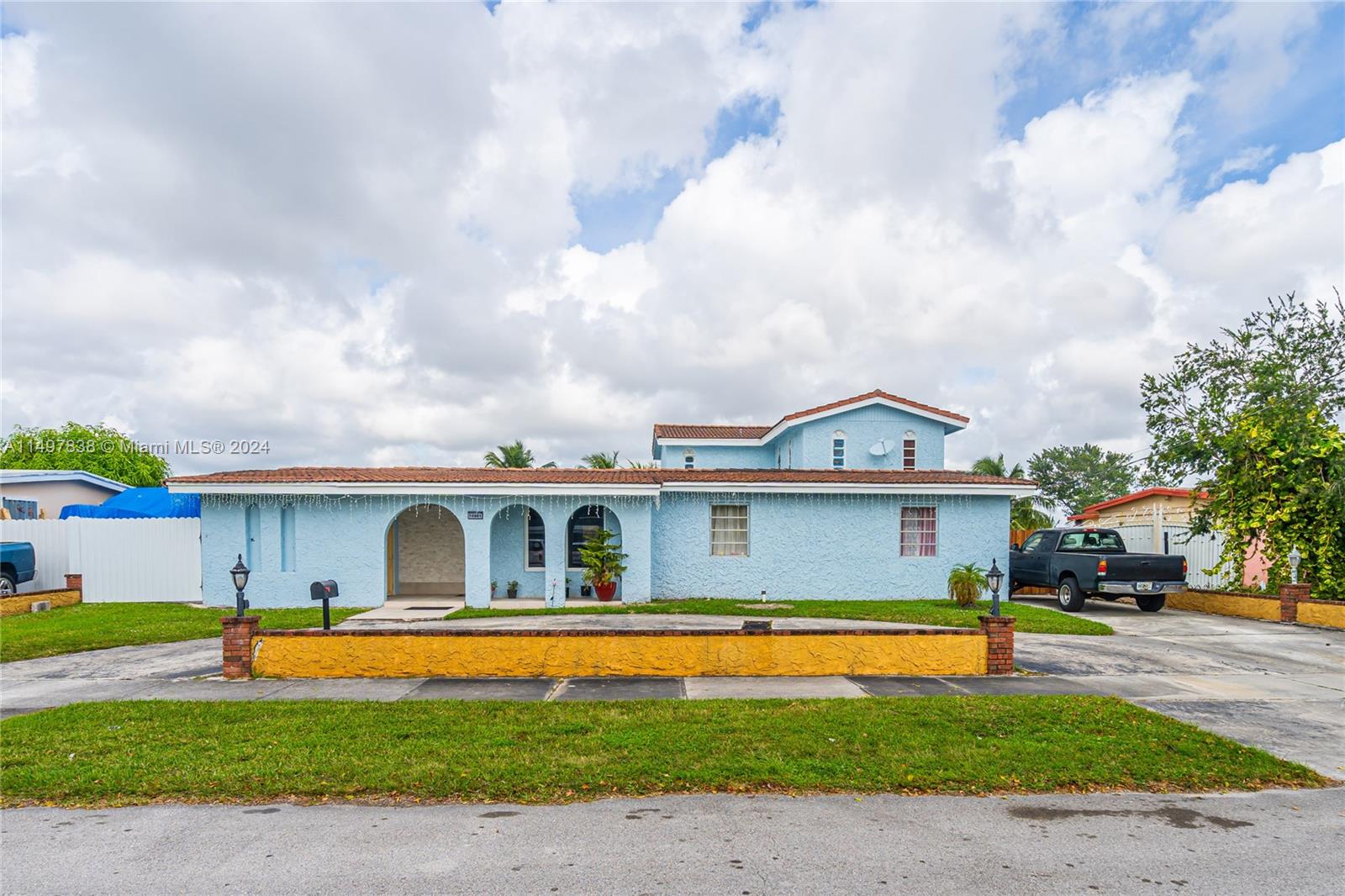 10981 Southwest 44th Street Miami, FL 33165 - Photo 6 of 52 a front view of a house with a yard