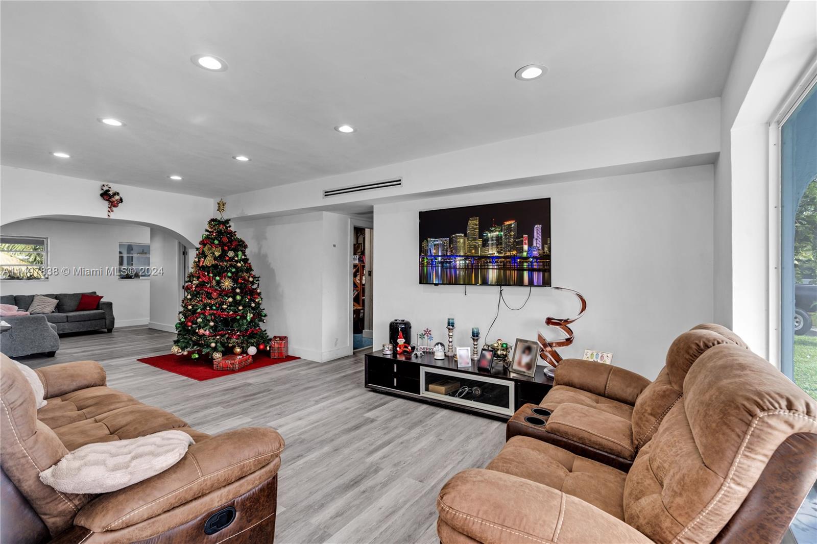 10981 Southwest 44th Street Miami, FL 33165 - Photo 9 of 52 a living room with furniture and a flat screen tv
