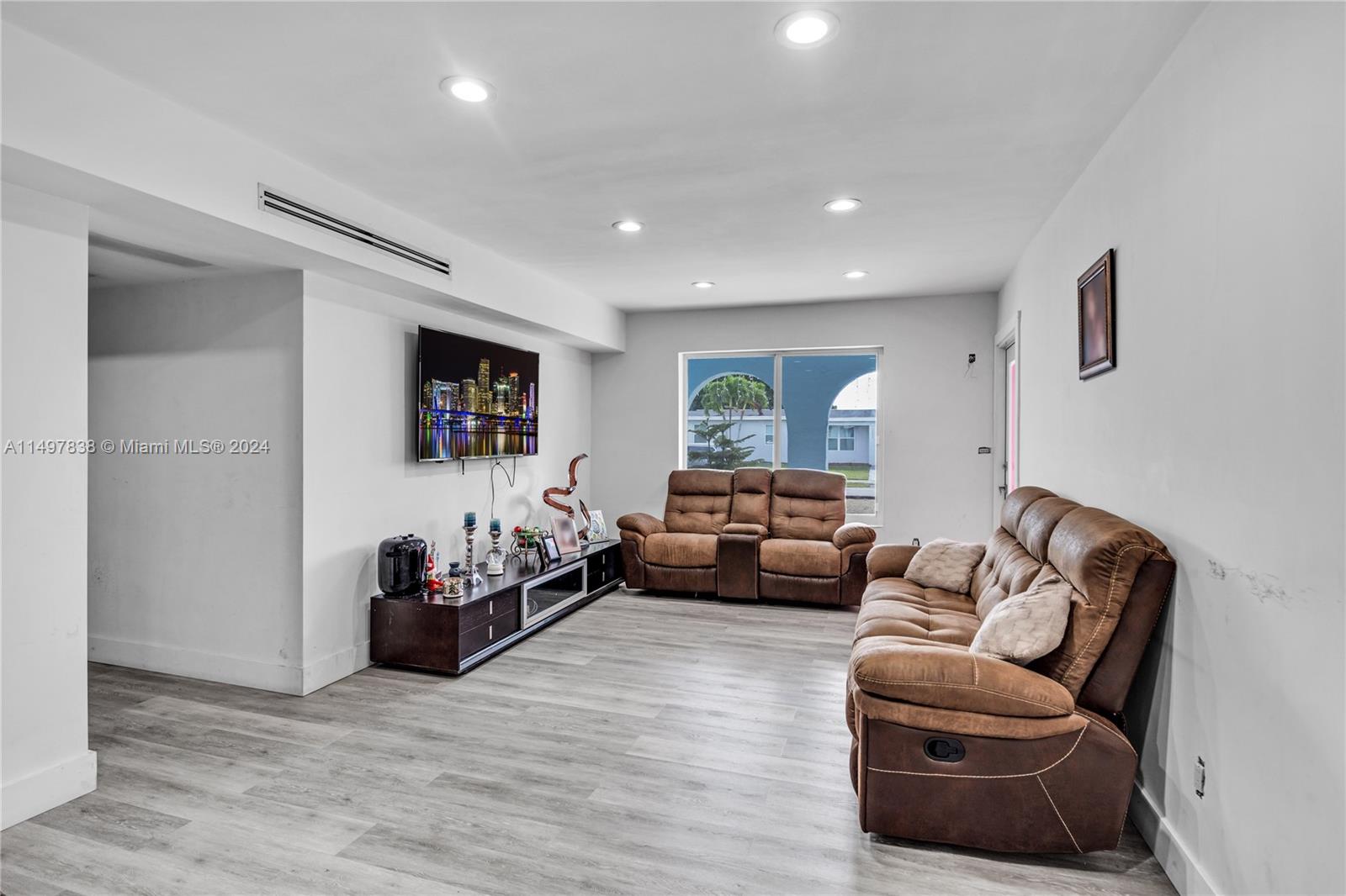 10981 Southwest 44th Street Miami, FL 33165 - Photo 10 of 52 a living room with furniture and a flat screen tv