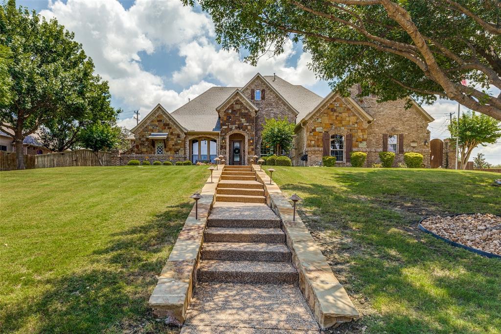 229 Arbor Lane Haslet, TX 76052 - Photo 1 of 34 Stone-clad exterior featuring a prominent gabled roofline