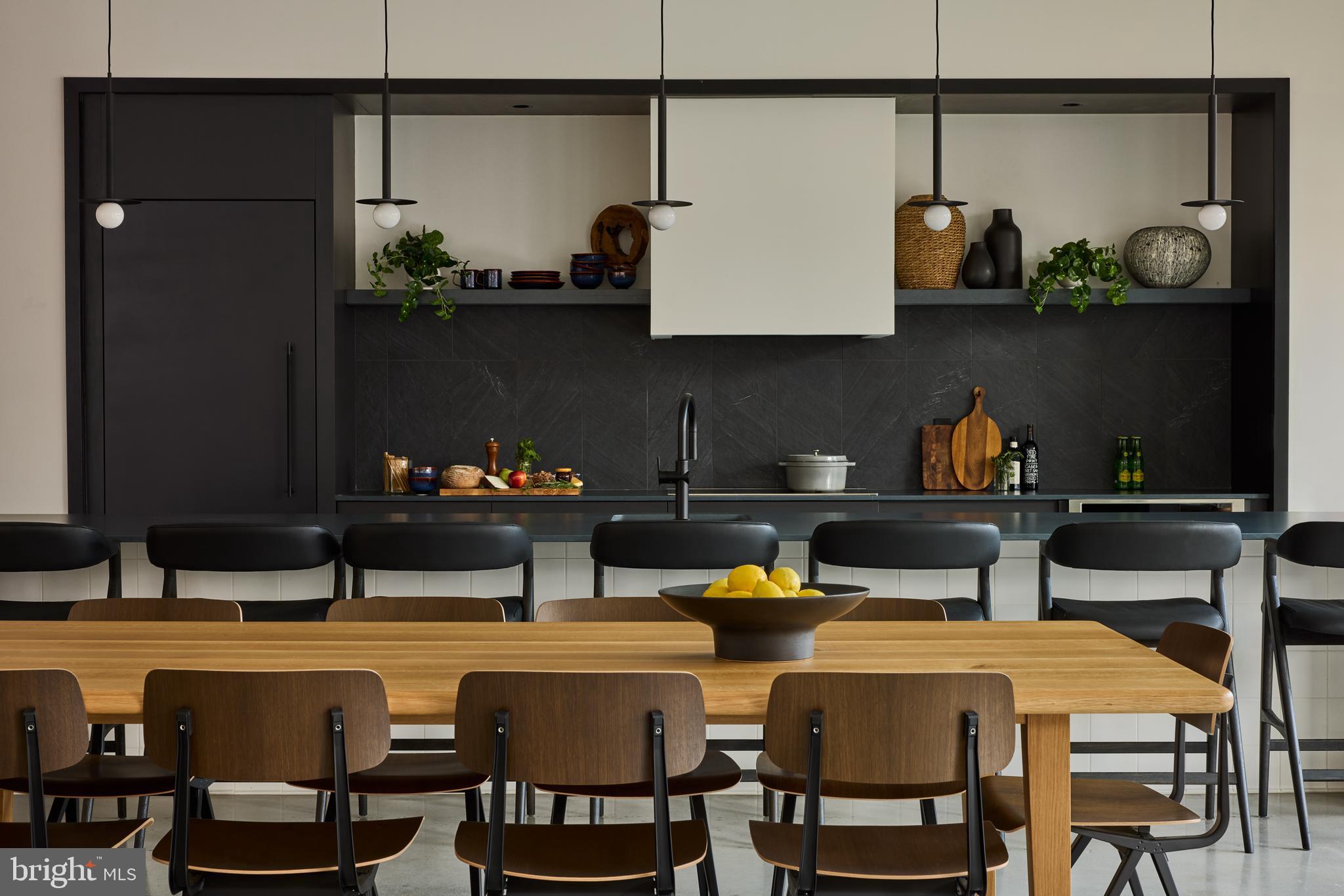 1134 Sansom Street, Unit 2B1708 Philadelphia, PA 19107 - Photo 17 of 33 a kitchen with a table chairs stove and cabinets
