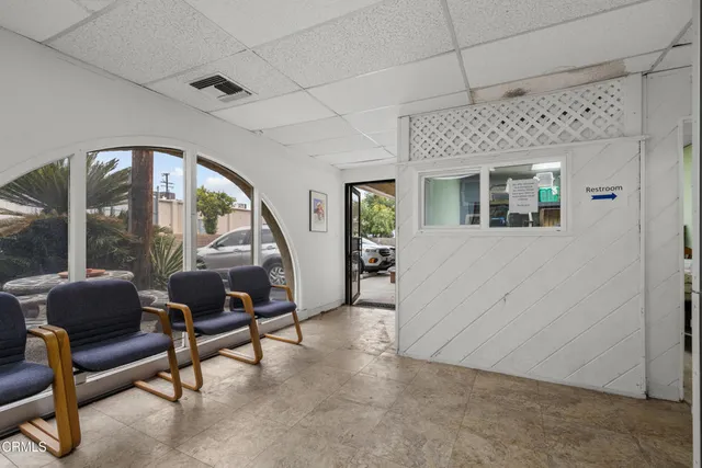 a livingroom with workspace and a couch