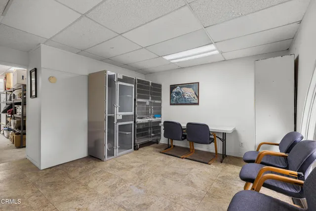 a room with furniture a rug toys and windows