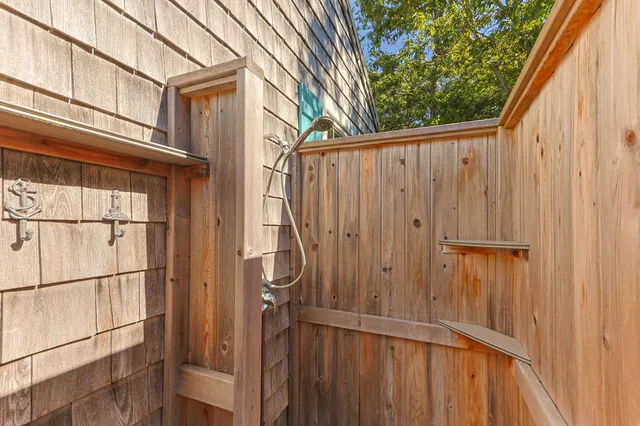 a view of a house with a wooden fence