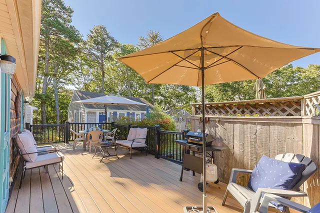 a view of a balcony with furniture and umbrella