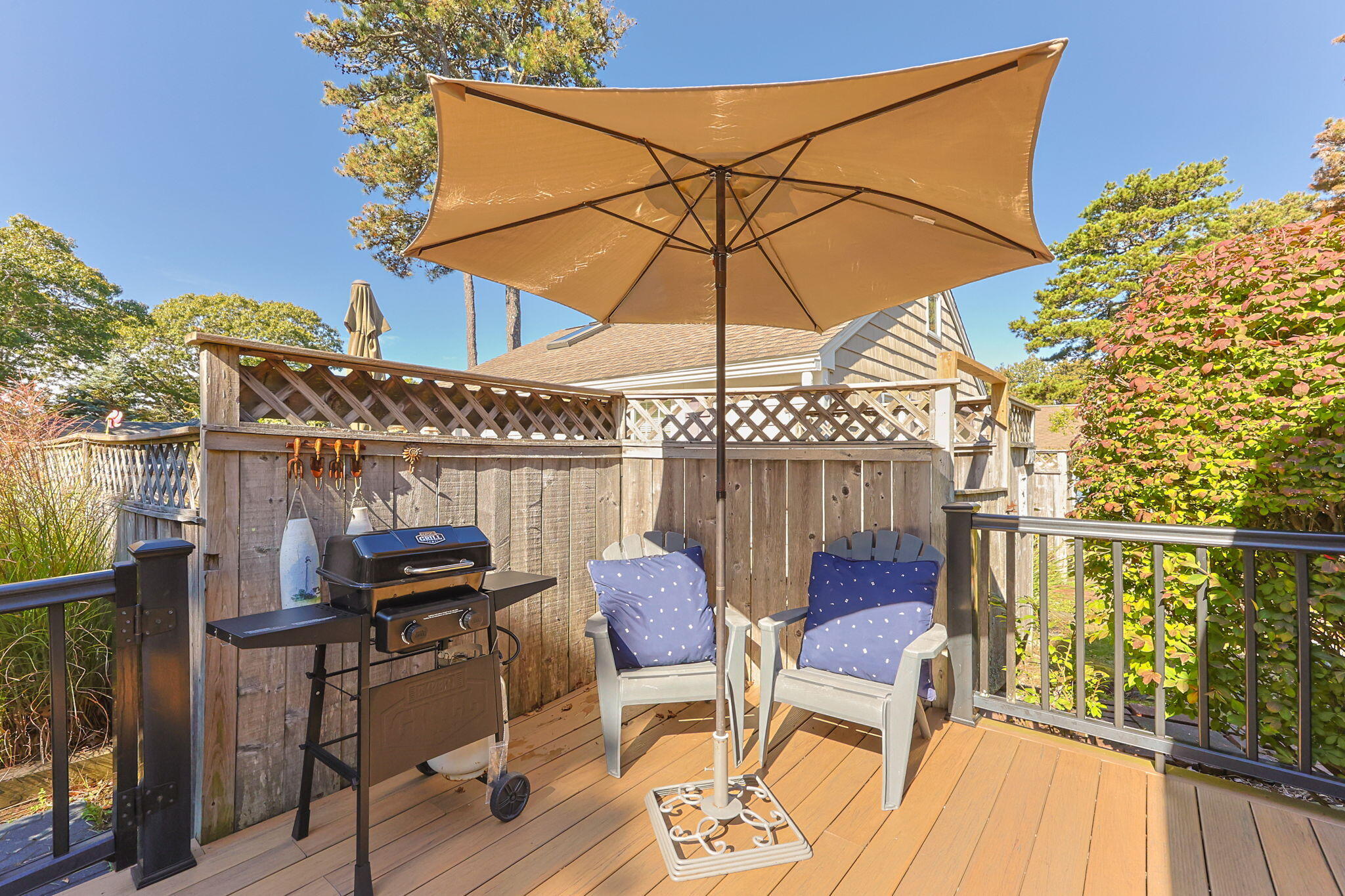 2032 State Hwy Route, Unit F/ (6) Wellfleet, MA 02667 - Photo 29 of 37 a view of a balcony with furniture and umbrella