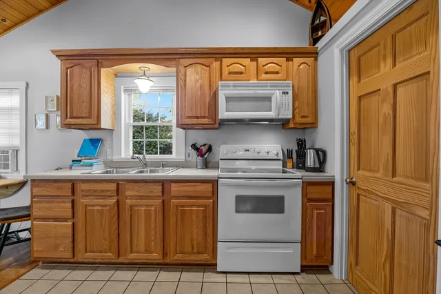 a kitchen with a stove a sink and a microwave