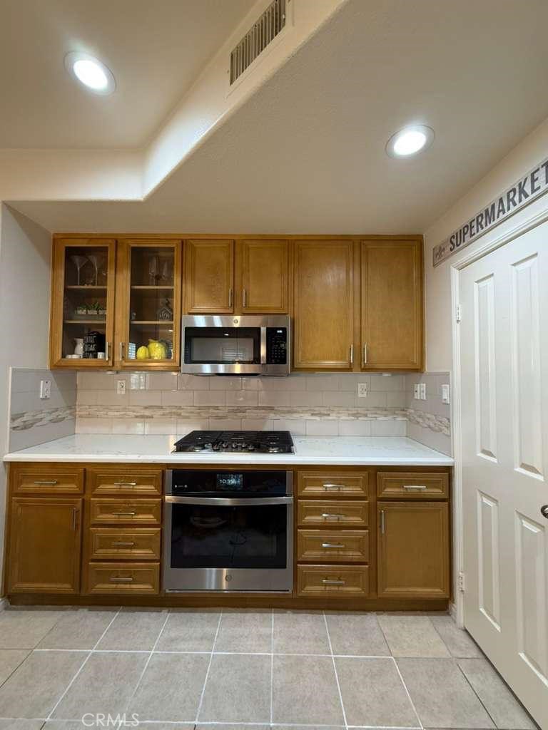 2931 Esperanza Way, Unit B Simi Valley, CA 93063 - Photo 16 of 49 a kitchen with stainless steel appliances granite countertop a stove and a sink
