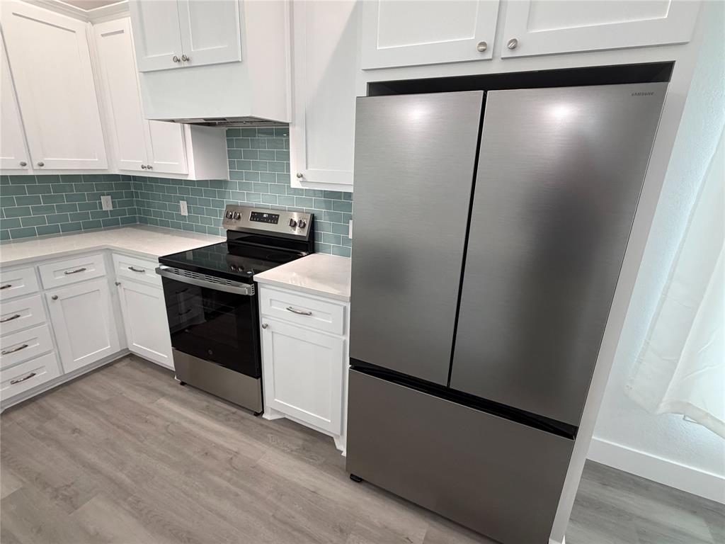 4200 Williams Road Bellmead, TX 76705 - Photo 8 of 22 a kitchen with a refrigerator and a sink