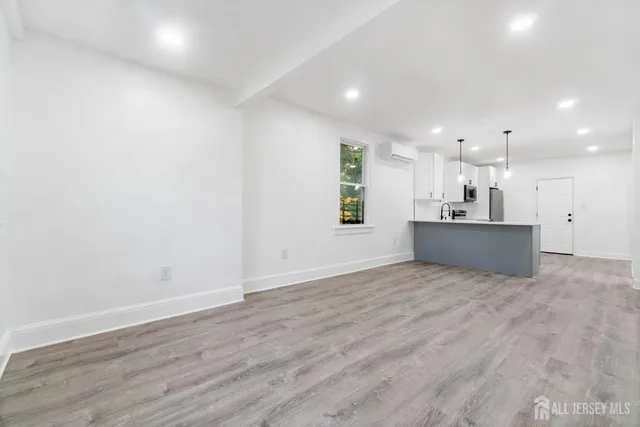 a view of a kitchen with a sink and a refrigerator