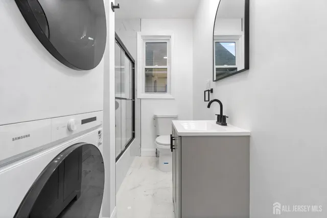 a bathroom with a sink a toilet and a mirror