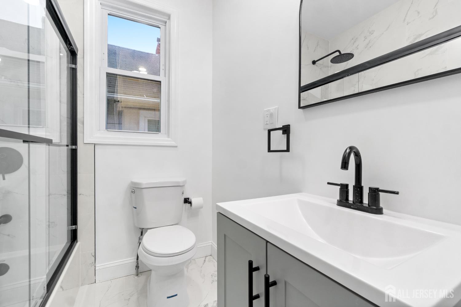 427 Benner Street, Unit 2 Highland Park, NJ 08904 - Photo 10 of 18 a bathroom with a sink a toilet and a mirror