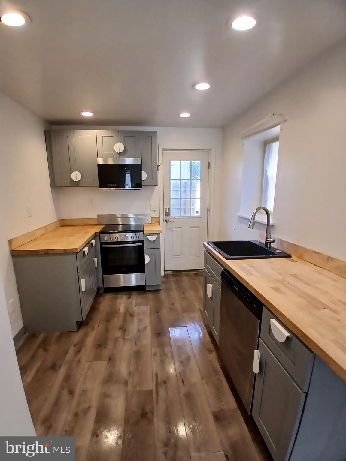 4511 Laird Street Philadelphia, PA 19139 - Photo 6 of 20 a large kitchen with stainless steel appliances a sink and a stove