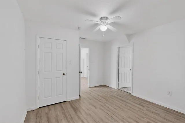 a view of an empty room and wooden floor