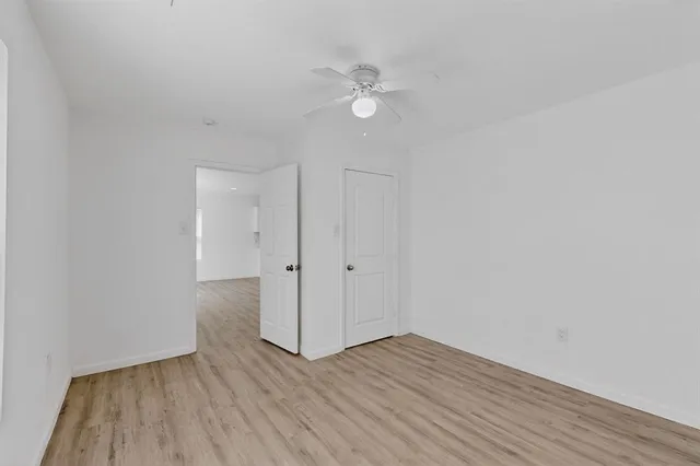 a view of an empty room and wooden floor