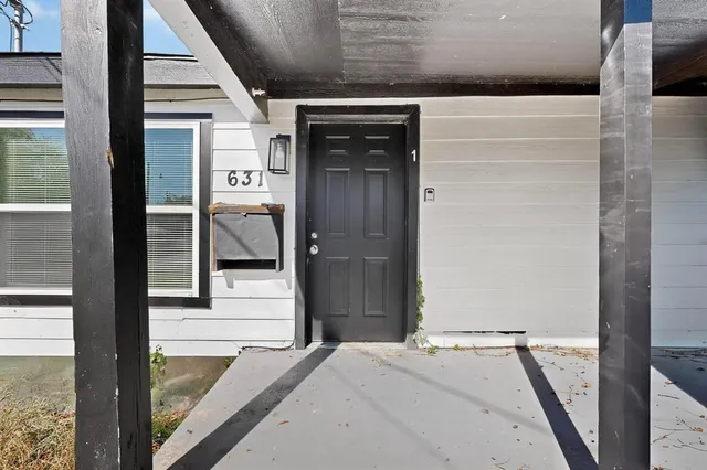 a view of a hallway with wooden floor and a building view