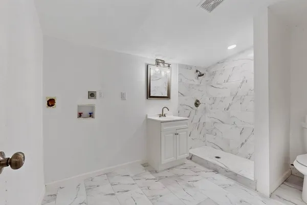 a bathroom with a sink toilet and shower