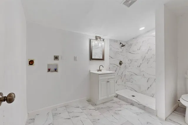 a bathroom with a sink toilet and shower