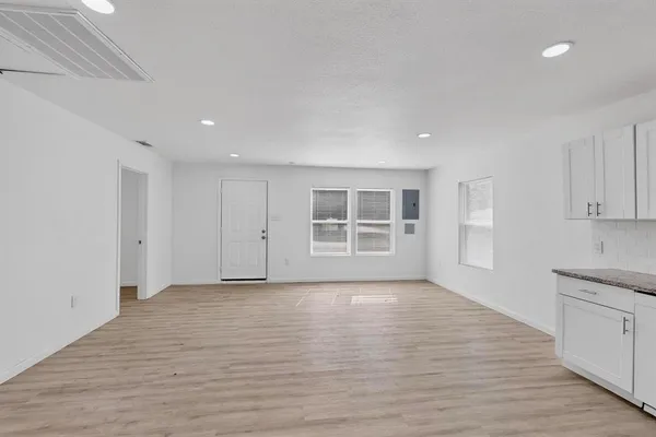 a view of wooden floor and windows in a room