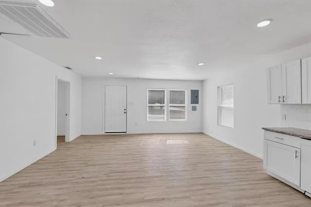 a view of wooden floor and windows in a room