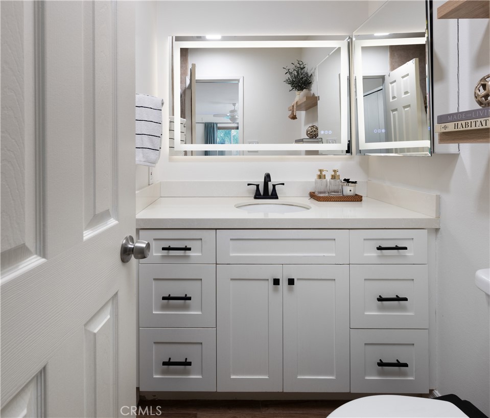 12200 Montecito Road, Unit D104 Seal Beach, CA 90740 - Photo 17 of 25 a bathroom with a sink a toilet and a mirror