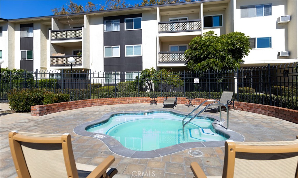 12200 Montecito Road, Unit D104 Seal Beach, CA 90740 - Photo 20 of 25 a swimming pool with outdoor seating and yard