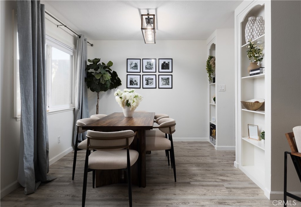 12200 Montecito Road, Unit D104 Seal Beach, CA 90740 - Photo 2 of 25 a view of a dining room with furniture and wooden floor
