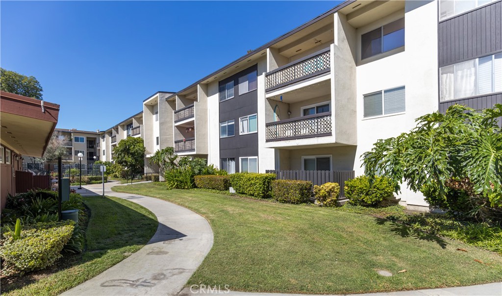 12200 Montecito Road, Unit D104 Seal Beach, CA 90740 - Photo 22 of 25 a view of a building with a yard