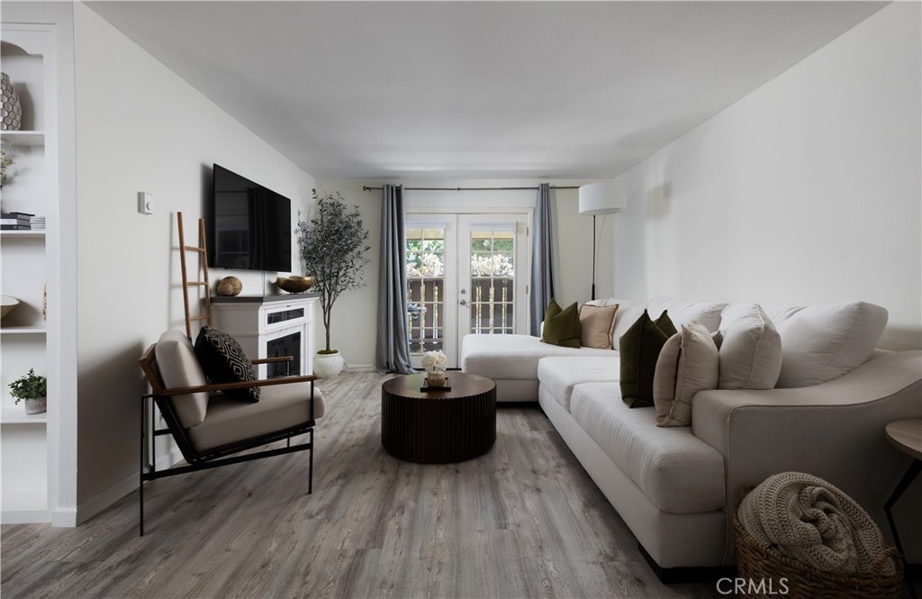 12200 Montecito Road, Unit D104 Seal Beach, CA 90740 - Photo 4 of 25 a living room with furniture and a flat screen tv