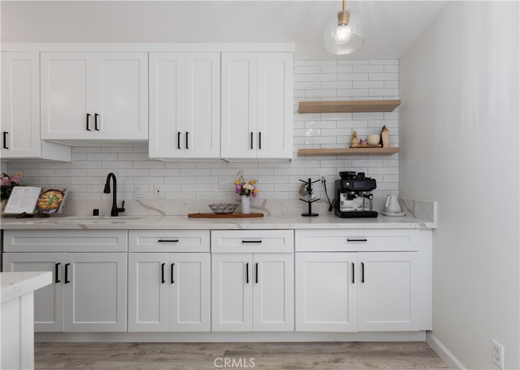 12200 Montecito Road, Unit D104 Seal Beach, CA 90740 - Photo 8 of 25 a kitchen with white cabinets and sink