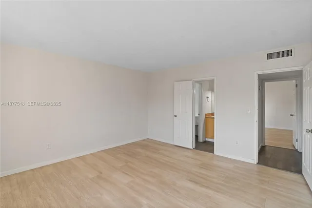 a view of an empty room and wooden floor