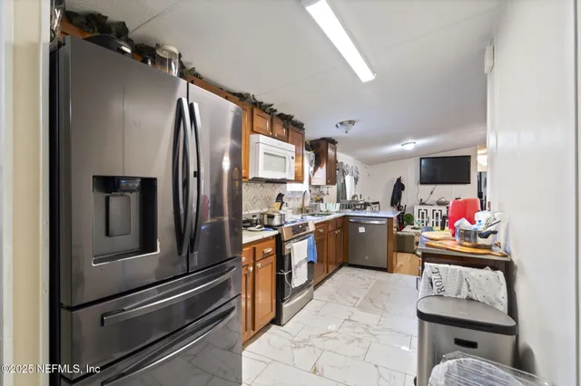a kitchen with refrigerator and cabinets