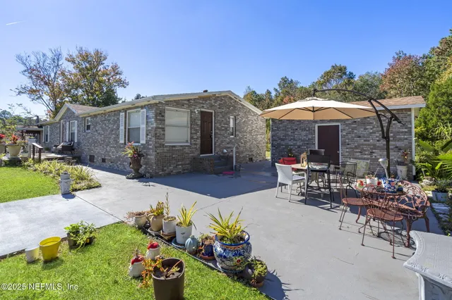 a view of a patio with furniture and a fire pit