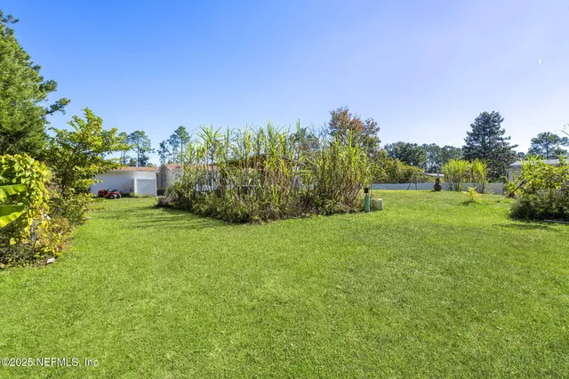 a backyard of a house with lots of green space and outdoor seating