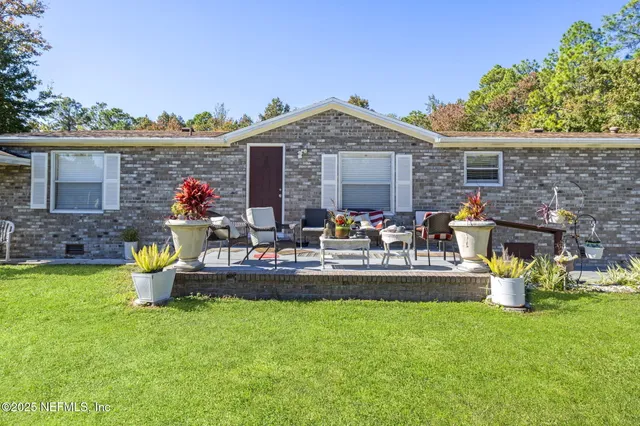a front view of a house with swing and a patio