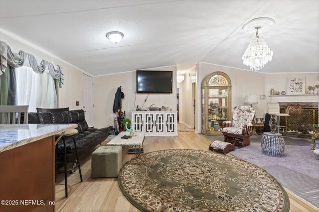 a bed room with a bed mirror and a flat tv screen