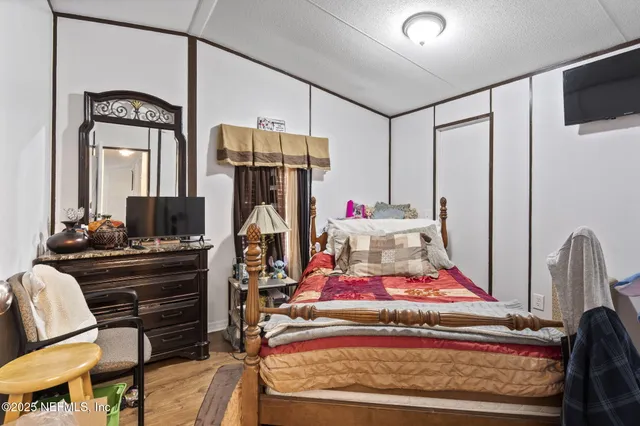 a bedroom with furniture and a mirror