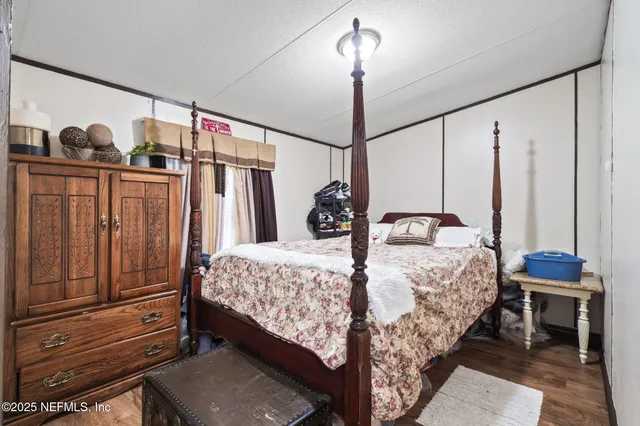 a bedroom with bed and window