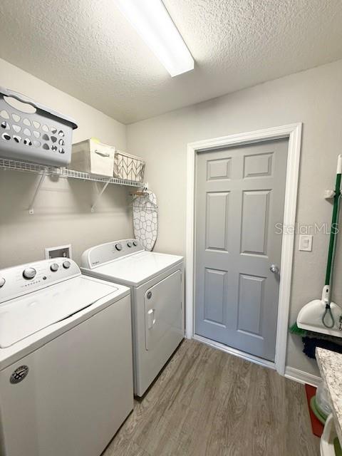 5497 Southeast 91st Street Ocala, FL 34480 - Photo 11 of 29 a view of washer and dryer with kitchen in the background