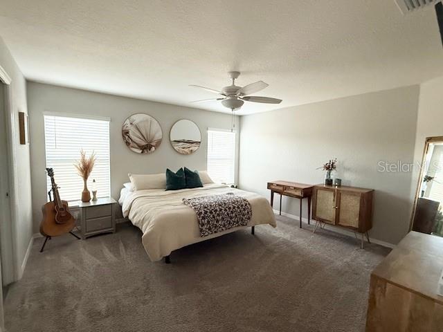 5497 Southeast 91st Street Ocala, FL 34480 - Photo 13 of 29 a bed room with a bed and a chandelier