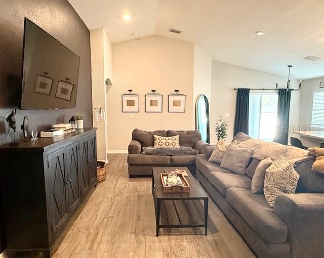 5497 Southeast 91st Street Ocala, FL 34480 - Photo 6 of 29 a living room with furniture and a wooden floor