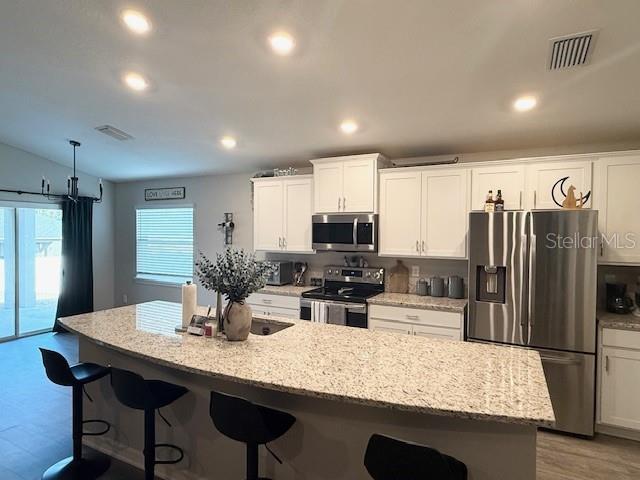 5497 Southeast 91st Street Ocala, FL 34480 - Photo 7 of 29 a kitchen with stainless steel appliances granite countertop a sink refrigerator and cabinets