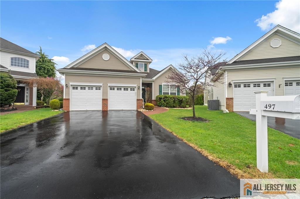 497 Hillrose Way, Unit 497 Monroe Township, NJ 08831 - Photo 1 of 28 a front view of a house with a yard and garage
