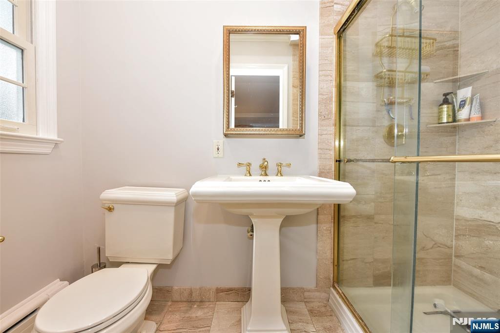 60 Dimmig Road Upper Saddle River, NJ 07458 - Photo 26 of 40 a bathroom with a sink toilet and shower